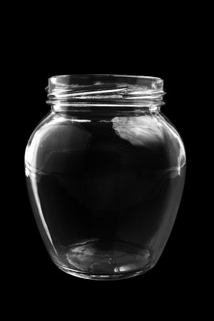 Glass bottle on black background (isolated, close up)の写真素材