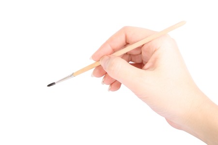 Draw brush in hand on white backgroundの写真素材