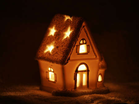 Macro photo of small candle winter houseの写真素材