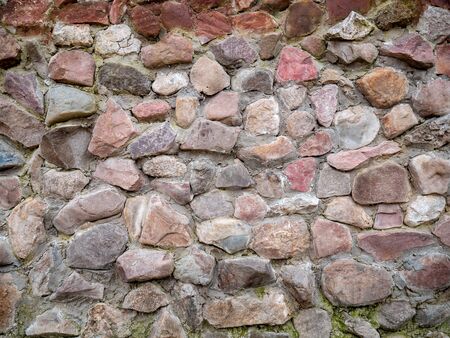 Texture of an old stone wall with cement. Uneven texture of natural stone with cracks for design or background.の写真素材
