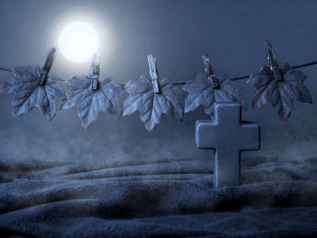 Halloween. A terrible grave cross and the Moon in a terrible place at night. Halloween scene with a...