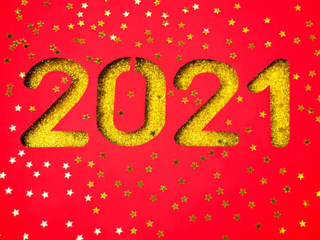 New year 2021 on bright red with numbers and shiny stars.