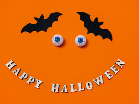 Scary and funny eyes on an orange background for Halloween, copy space.の写真素材