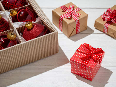 Christmas box with red Christmas balls and gifts, Christmas trinkets.