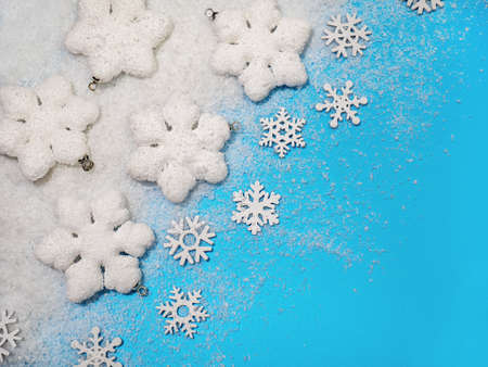 Christmas background. White decorations Christmas balls and snowflakes on soft snow, copy space, place for textの写真素材