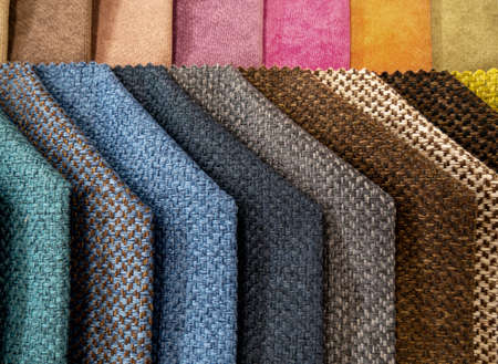 Catalog of colorful samples of fabrics for the manufacture of furniture. Collection of furniture fabrics selective focusの写真素材
