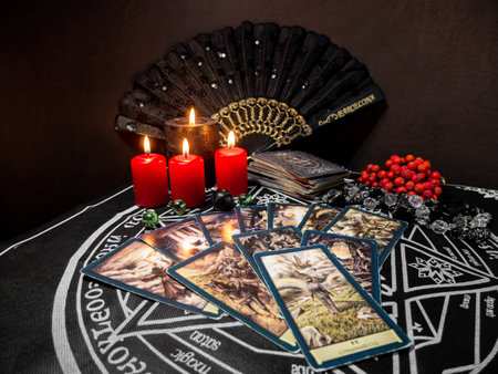 Russia, Dzerzhinsk, October 09, 2021. Cartomancy, fortune telling, predictions on tarot cards. There are witchy objects, candles on the fortune-telling table. The concept of astrology and esotericism.のeditorial素材