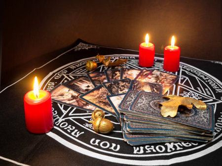 Russia, Dzerzhinsk, October 09, 2021. Cartomancy, fortune telling, predictions on tarot cards. There are witchy objects, candles on the fortune-telling table. The concept of astrology and esotericism.のeditorial素材