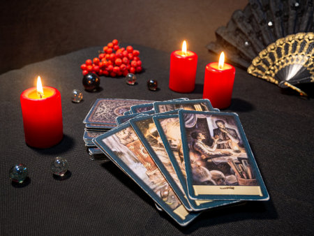 Russia, Dzerzhinsk, October 09, 2021. Cartomancy, fortune telling, predictions on tarot cards. There are witchy objects, candles on the fortune-telling table. The concept of astrology and esotericism.のeditorial素材