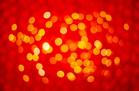 Abstract red festive sparkling background with golden bokeh lights and sequins. Chinese New Year.