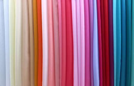 The assortment of silk fabrics in the store. Colorful, bright textiles. Collection of fabrics.