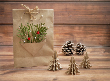 Gift bag for Christmas and New Year, decorated with New Year decor. Surprise gift in a craft package. Eco friendly packaging, paper recycling, zero waste, natural products conceptの写真素材