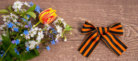 9th May. The concept of the Great Victory Day of 1941-1945 and Defender of the Fatherland Day. St. George ribbon on a wooden background. bannerの写真素材