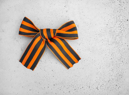 9th May. The concept of the Great Victory Day of 1941-1945 and Defender of the Fatherland Day. St. George ribbon on a concrete backgroundの写真素材