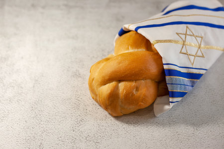 Challah bread covered with a cloth with a star of David. A traditional Jewish Sabbath ritual....