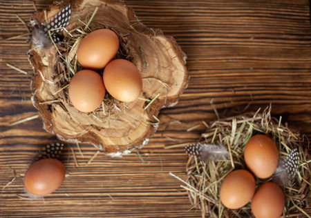 Easter eggs in a nest on a wooden background Greeting Easter card rustic style. chicken eggs..