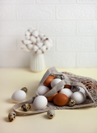 Chicken eggs in a textile bag. home interior with Easter decor. A minimalistic Easter celebration concept. Place for the text.の写真素材