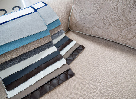 Catalog of fabrics and artificial leather for the manufacture of upholstered furniture. Samples of multicolored fabrics. Choosing the color of the sofa. Background for the textile industry.の写真素材