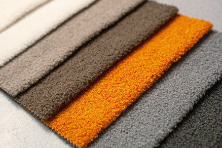 Furniture textiles for the interior of the house. Samples of soft upholstery fabrics. a close-up view of the catalog. a cozy collection of velour and boucle textile fabrics for furniture.の写真素材
