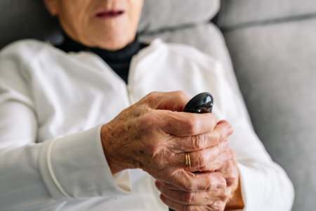 older woman listening to music while doing household chores, sweeping