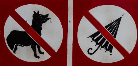 No dog and umbrella signs are shown at a museum.の写真素材