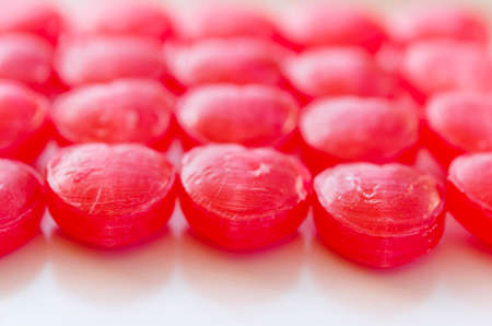lots of heart-shaped red candy arranged as background for valentine dayの写真素材