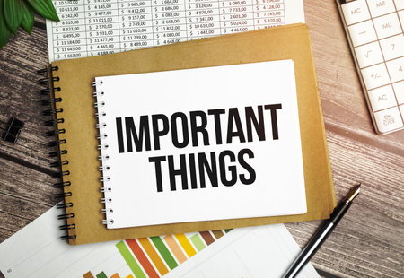 Notebook written with Important Things word on wooden background. Business Concept.の写真素材