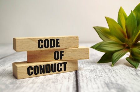 Code of conduct symbol. Concept words Code of conduct on wooden blocks on white backgroundの写真素材