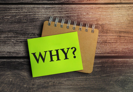 question why on green sticker and wooden background
