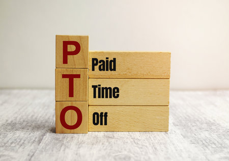 On the wooden blocks with the inscription - paid time offの写真素材