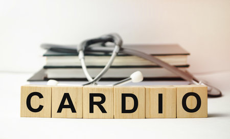 The word CARDIO is written on wooden cubes near a stethoscope on a wooden background. Medical conceptの写真素材