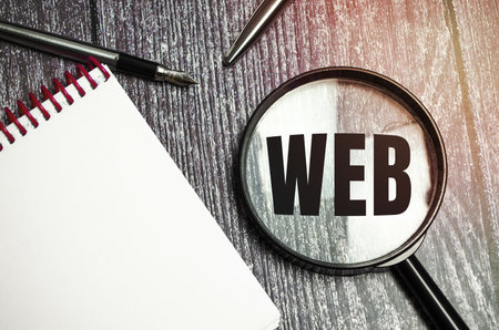 Web development concept Web word on magnifier. Development