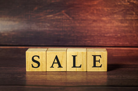 Word sale made from wooden blocks on wooden backgroundの写真素材