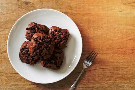 dark chocolate brownies with chocolate chips on topの写真素材