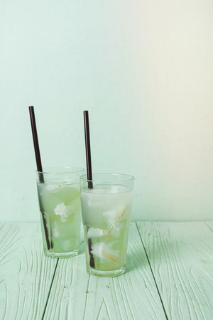 coconut water or coconut juice in glas with ice cubeの写真素材