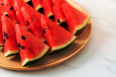 fresh watermelon sliced on wooden plate
