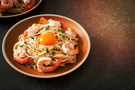 homemade spaghetti white cream sauce with shrimps and egg yolkの写真素材