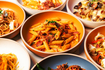 penne pasta with garlic chili bacon on plateの写真素材