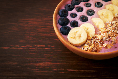 yogurt or yoghurt smoothie bowl with blue berry, banana and granola - Healthy food styleの写真素材