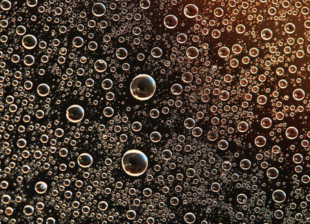 Drops on glass of different sizes and colors on a colored background, texture.の写真素材