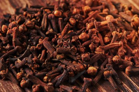 Dried spice herbs cloves for flavoring foods and natural medicines, Indian spice ingredient on wooden background.の写真素材