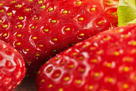 Fresh selected strawberries, stacked in slide on wooden background. Close up.の写真素材
