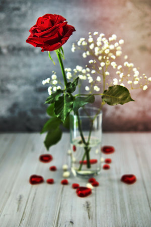 Romantic still life, red rose, chocolate in the shape of hearts on a light background. Valentine's day concept. Soft focusの写真素材