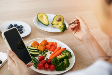 Dieting, hand of asian young woman eating, holding fork at broccoli, diet plan nutrition with fresh...