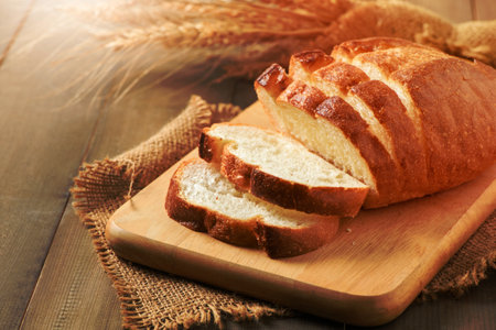 Sliced of fresh homemade french breads on wood background, bakery concept