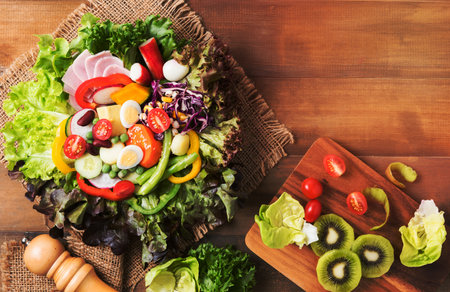 fresh mix vegetation salad on brown wood background, concept diet and healthy foodの写真素材