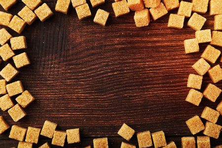 Brown sugar on brown wooden backgroundの写真素材