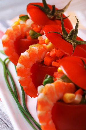 Fresh red tomatoes stuffed with vegetables and shrimp. macro. verticalの写真素材