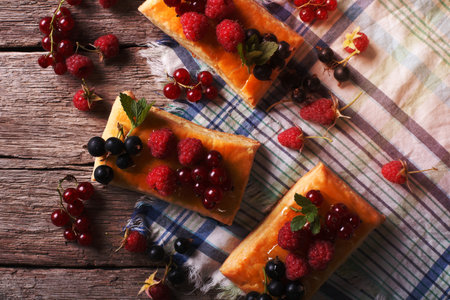 Delicious cookies with berries, honey and mint on a table close-up. horizontal view from above