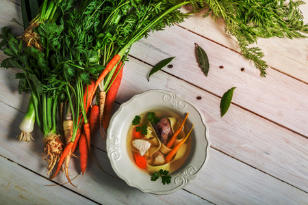Homemade broth with noodles and ingredientsの写真素材